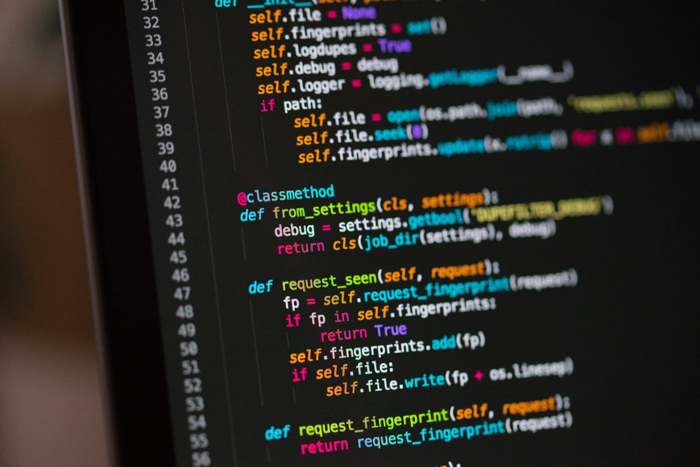 Developer screen showing colorful code in a dark editor