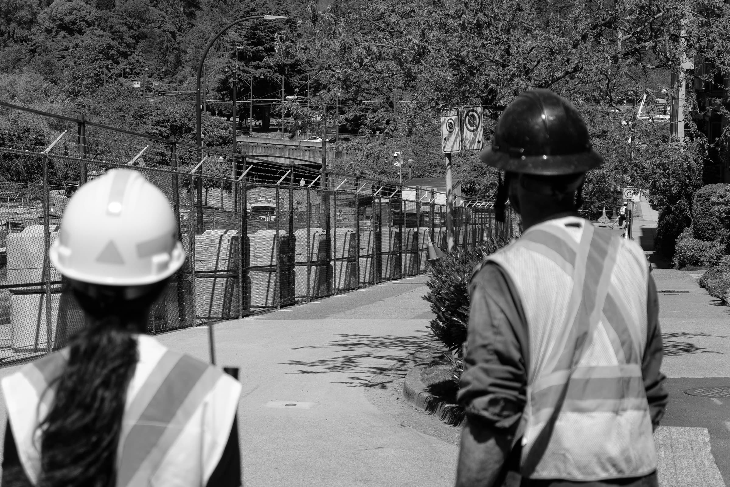 Active construction site with cranes and structural steel framework