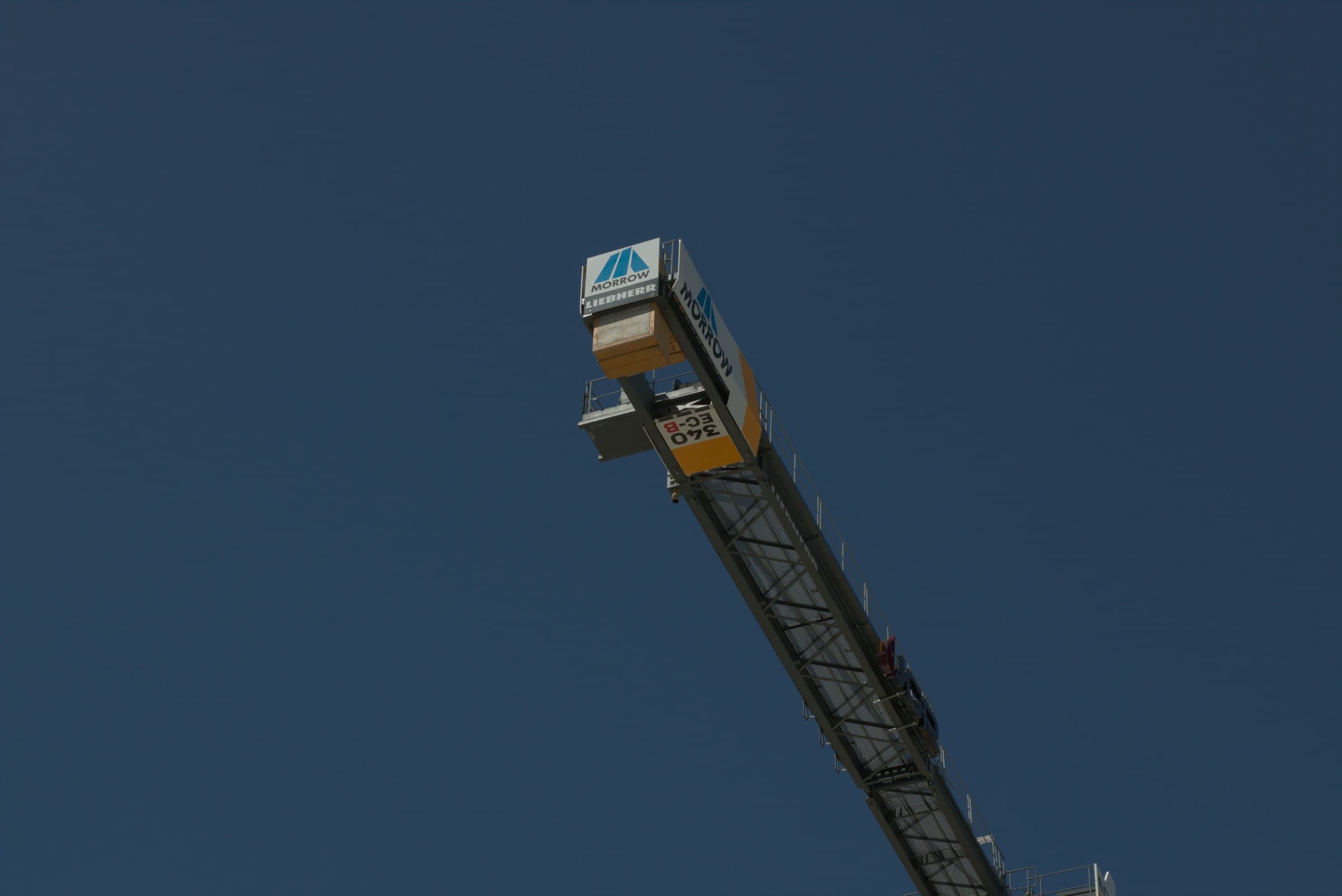Crane arm against a clear blue sky