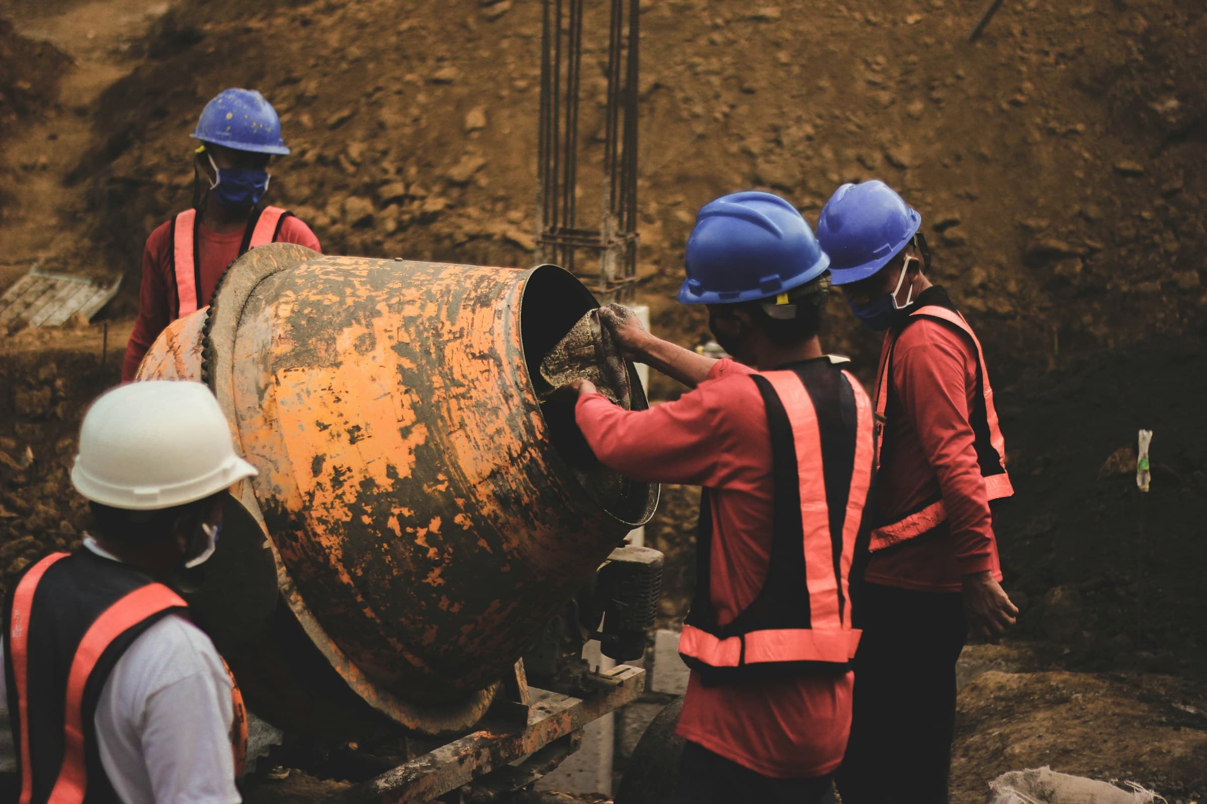 Engineer with hard hat and tablet inspecting an industrial site